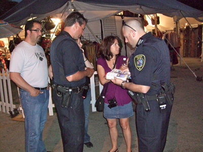 summerfest grounds. Officer Scott Siller cards an underage drinker on the Summerfest grounds.